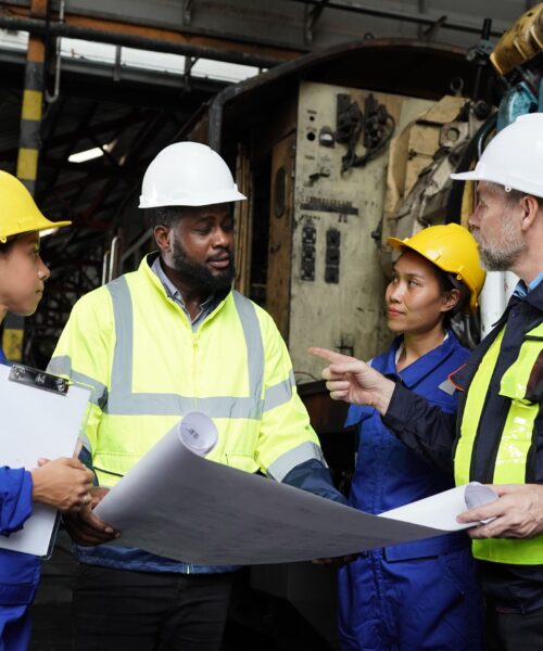 portrait-of-engineer-and-apprentice-in-workshop-of-2023-11-27-05-01-57-utc-min